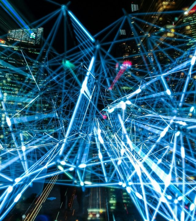 Dynamic urban scene showcasing interconnected light trails representing digital communication networks.